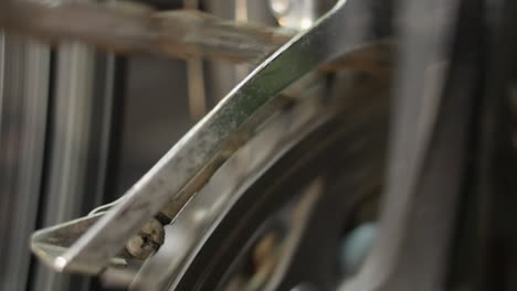 closeup: bicycle chainwheel turns slowly during drivetrain maintenance