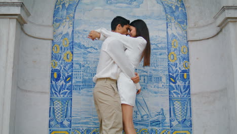 affectionate newlyweds embracing at tile place vertical. hispanic couple hugging