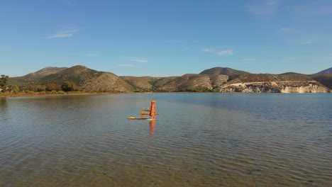 three sunbathing chairs in an empty shallow sea in greece