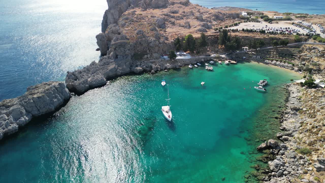 Famous St ’s Bay, Lindos aerial drone rotate around bay, sunny morning, Rhodes, Greece