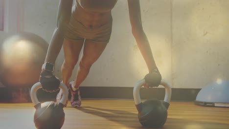 Digitally-generated-video-of-glowing-spots-against-woman-performing-push-ups-in-background