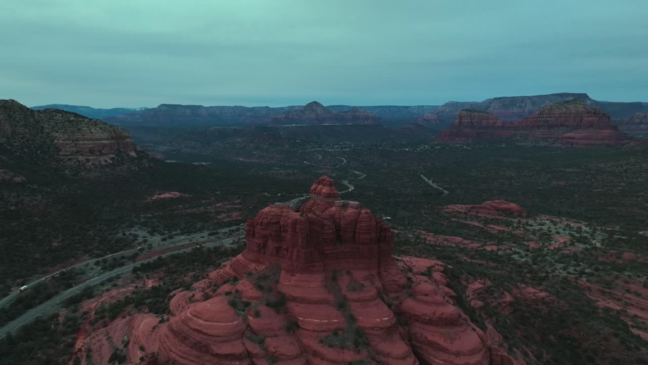 Bell Rock In Sedona Arizona's Red Rock Landscape At Sunset - aerial pullback