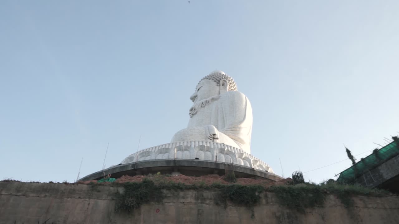 Statue of big white marble buddha in temple, side view, Phuket, Thailand