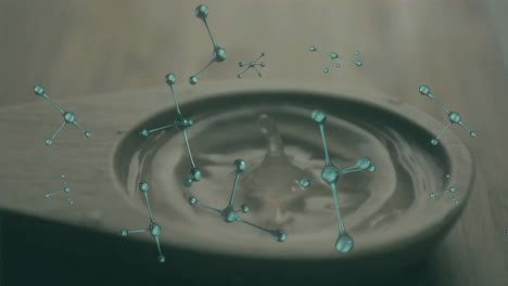 animating molecular structure over water ripples in wooden spoon