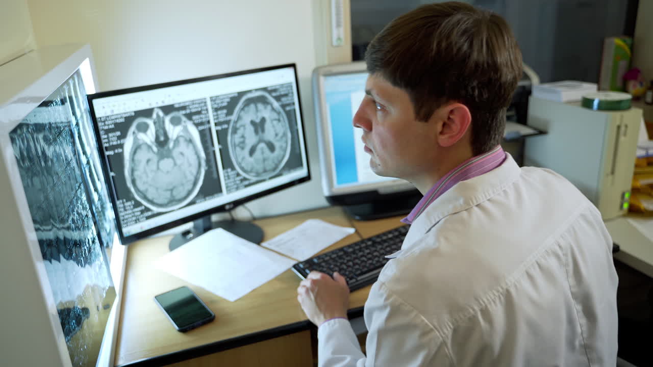 Doctor Looking Scans Results. Doctor looking at patient scans on computer screens in modern clinic