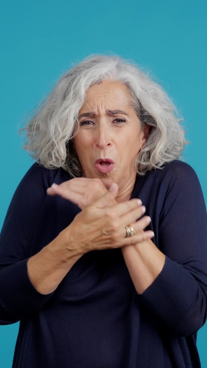 Senior woman shivering and trying to warm herself