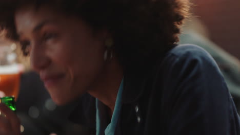happy mixed race woman laughing hanging out with friends celebrating reunion party in restaurant drinking enjoying celebration chatting having fun socialzing