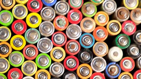 old used discarded aa cells and other electric batteries from old used discarded aa cells and other electric batteries from different manufacturers waste waste collection and recycling high risk they rotate on the turntable around their axis movement
