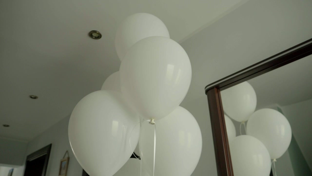 White balloon decoration inside a home, creating an elegant setting for wedding celebrations and preparations.
