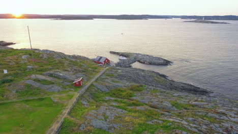 rocky seawall at the island of store torungen during golden sunset in agder county, norway