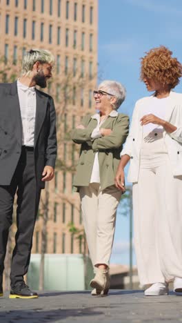 diverse business people talking relaxed while strolling in the city