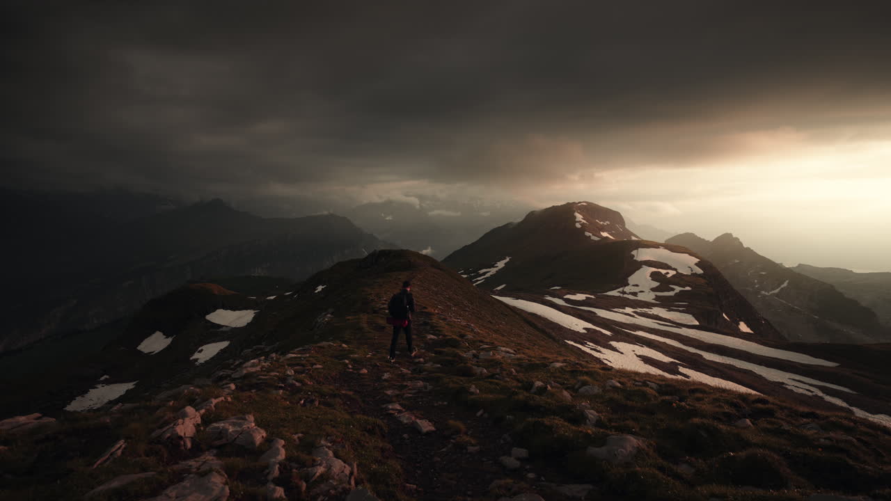 Hiker on Mountain Summit at Sunset