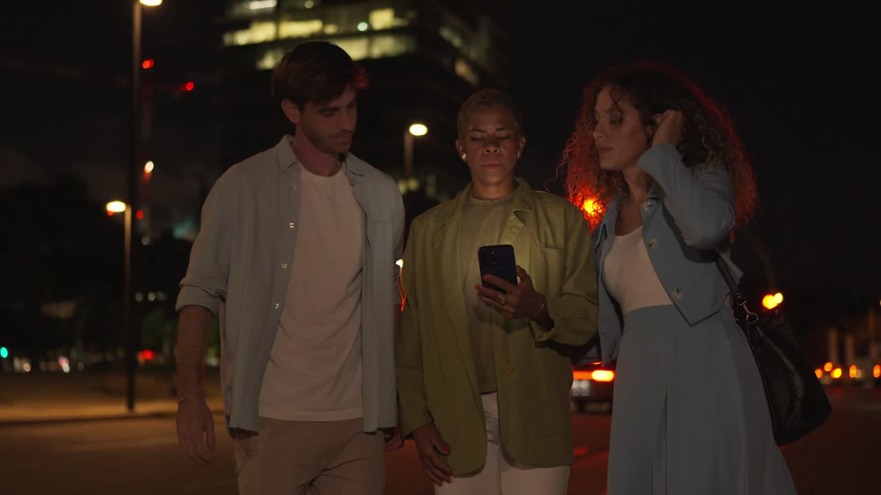 Group of people walking at night in the city