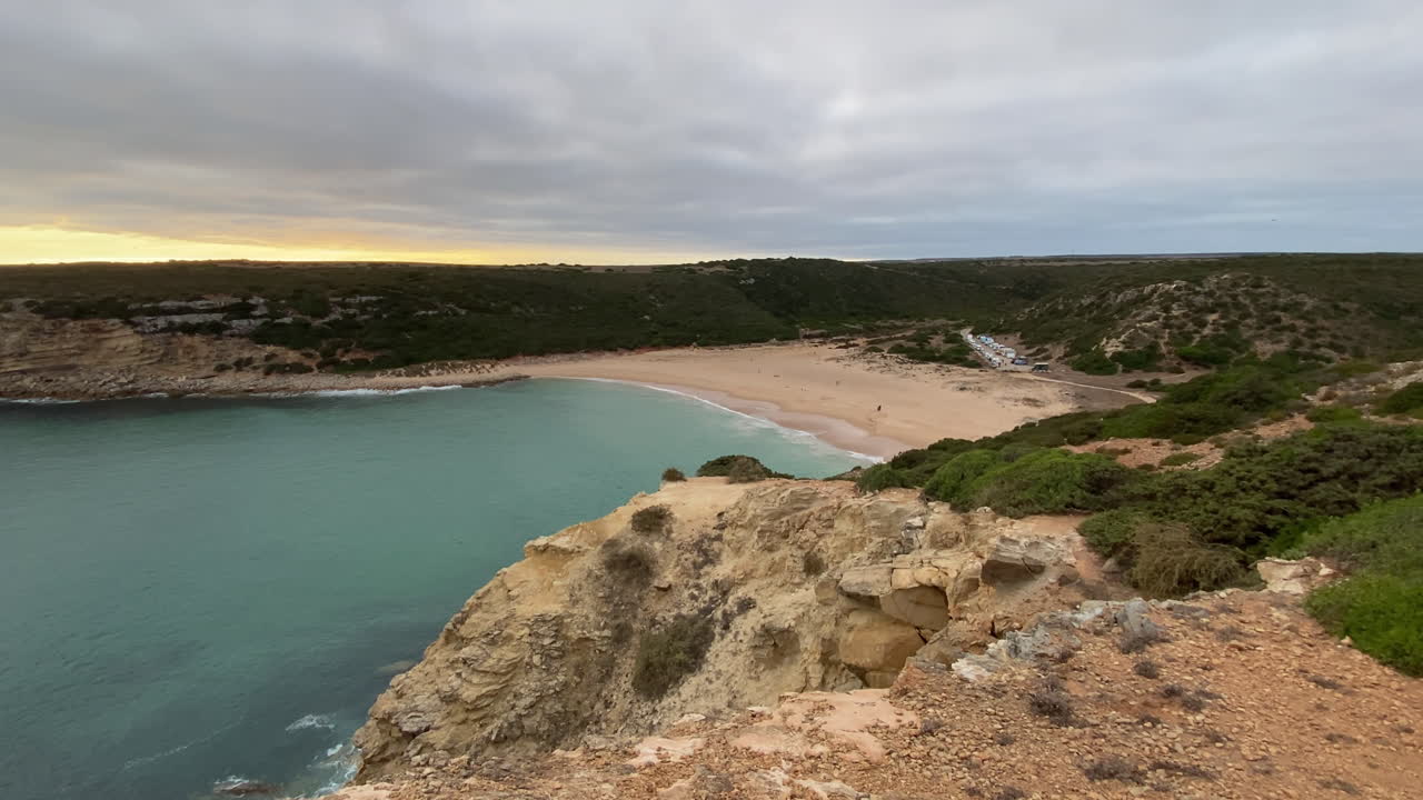 A sandy trail leads to the cliffs of Sagres under soft light and ocean breeze, pure Atlantic wilderness