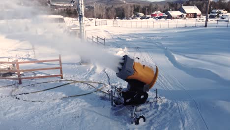 Orbit shot of snow gun blowing snow on the ski slope in Saint-Sauveur, Quebec, Canada