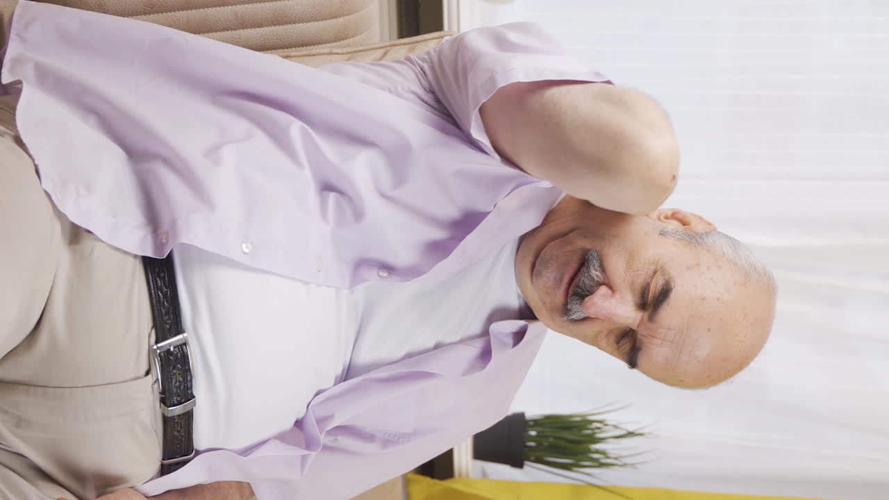Vertical video of Old man with neck pain.