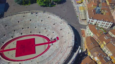 aerial view of arena di verona, italy. the drone flies over the arena and over the houses of the city. a view of the arena and the city opens.