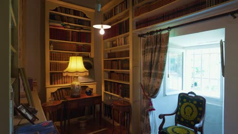 slow revealing shot of a home library with antique books in the shelf