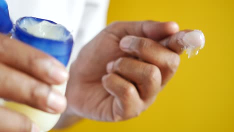 close up of man hand using petroleum jelly
