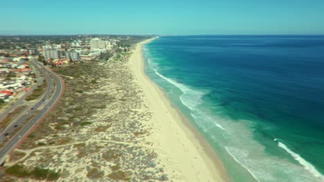 aerial view of a beautiful beach with city in the background