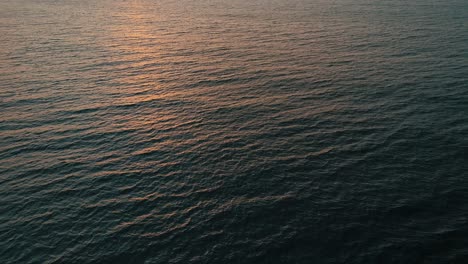 reflection of sunrise in the ocean aerial view