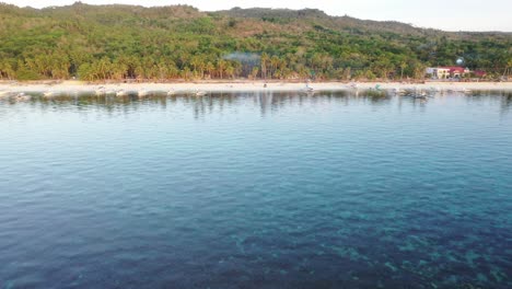 sunset aerial view of traditional philippines passenger boats at sun sea shore