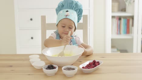 adorable smiling toddler at mixing bowl