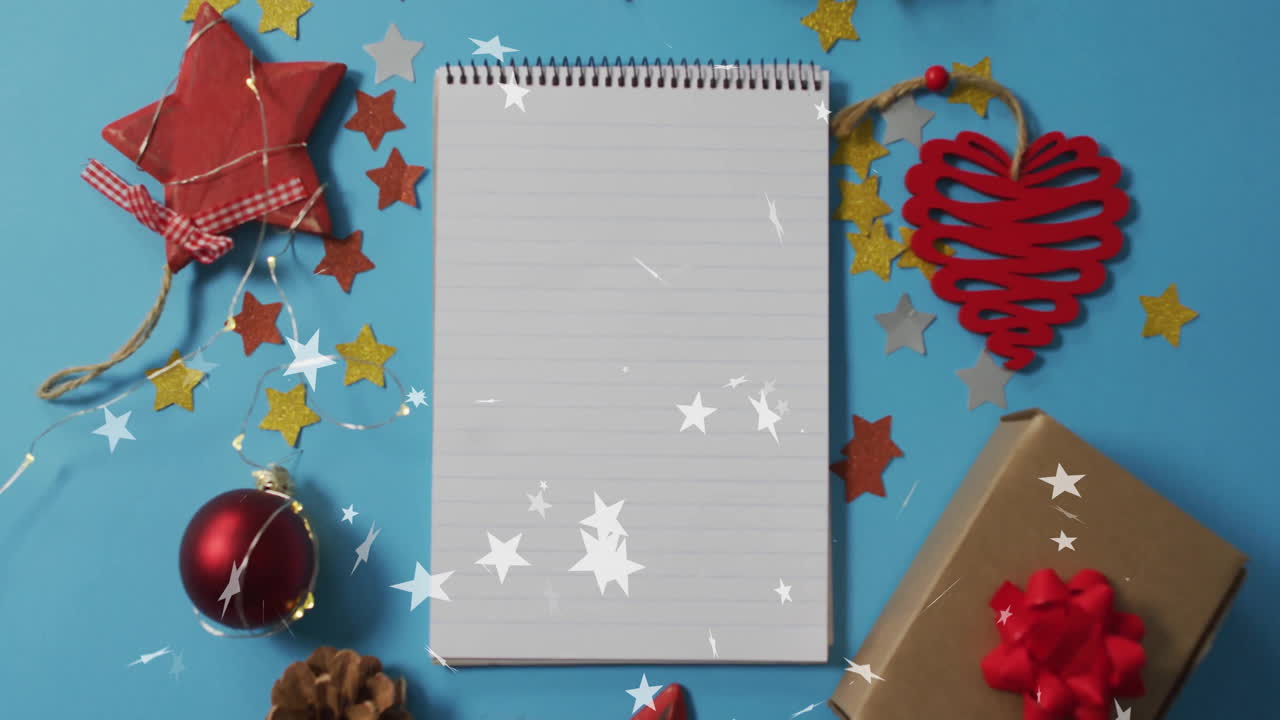 Christmas decorations on blue background with blank notepad and falling stars animation