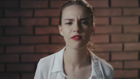 mujer nerviosa gritando y maldiciendo en el estudio. retrato ngry chica agitando la mano