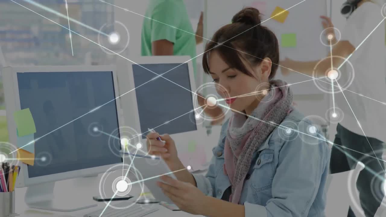 Animation of network of connections over thoughtful caucasian female graphic designer taking notes