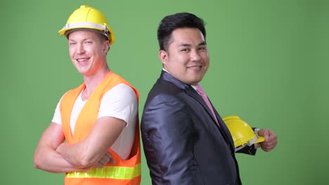 scandinavian man construction worker and asian businessman working together