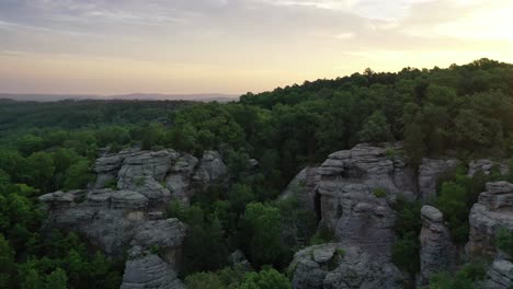 Rocky-cliff-overgrown-with-dense-forest-in-early-morning-sunrise-view