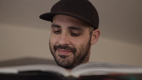 attractive caucasian man is studying for university. indoor shoot of young boy, that studies. study for success and learning concept. closeup shot of face in 4k