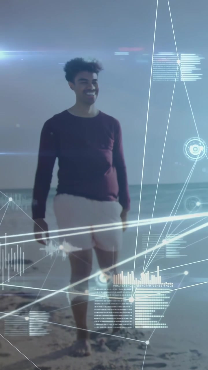 Vertical video: HUD sweeping in spurring man walking toward camera across shore nodes showing data