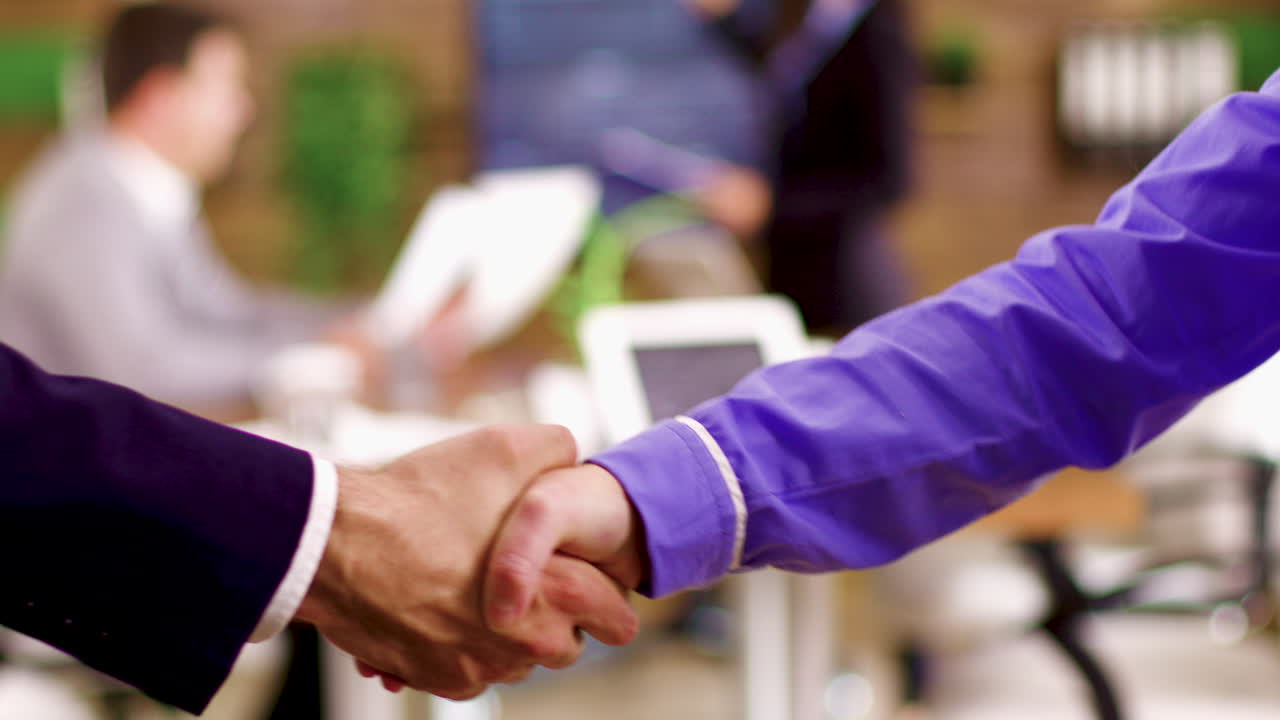 Close up of businessmen shaking hands after an agreement