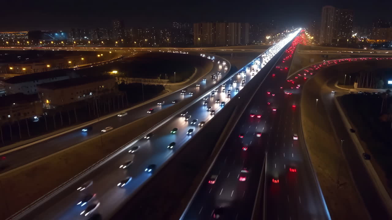 Aerial View of Busy Highway Interchange with Car Light Trails at Night
