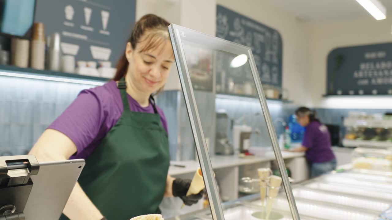 Woman selling ice cream in ice cream parlor