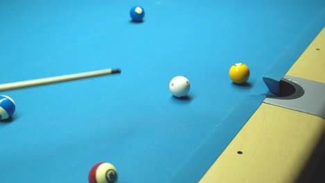 billiard, missed shot. blue table, rolling balls