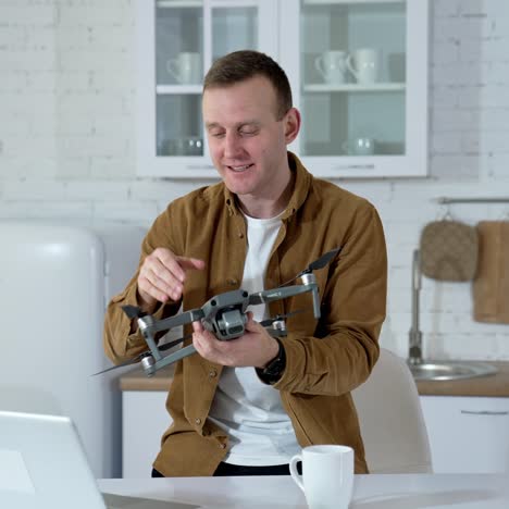 man at home with drone. young man playing with drone at home
