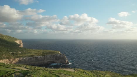 aerial: mediterranean sea wash coastline in malta on a sunny evening