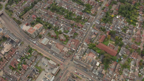 aerial shot over large motorway intersecting a uk city