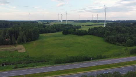 Highway-road-and-wind-turbine-farm,-aerial-drone-view