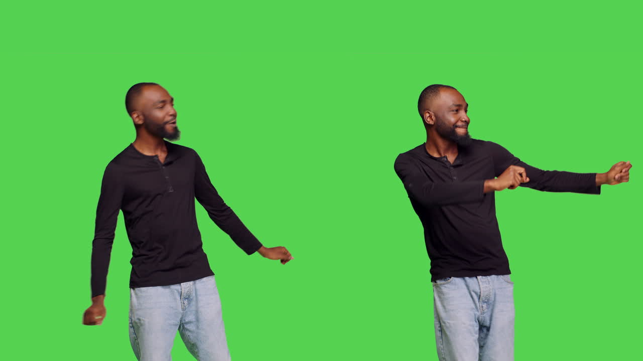Man dancing in front of a green screen
