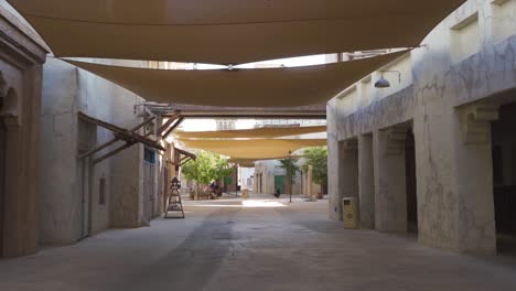 view of a peaceful neighbourhood with traditional structures in al fahidi historical district, dubai uae