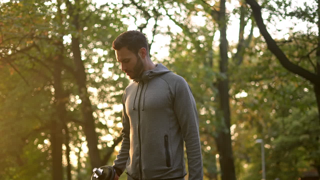 Man working out with dumbbell in the park