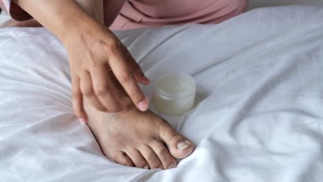 applying cream to feet