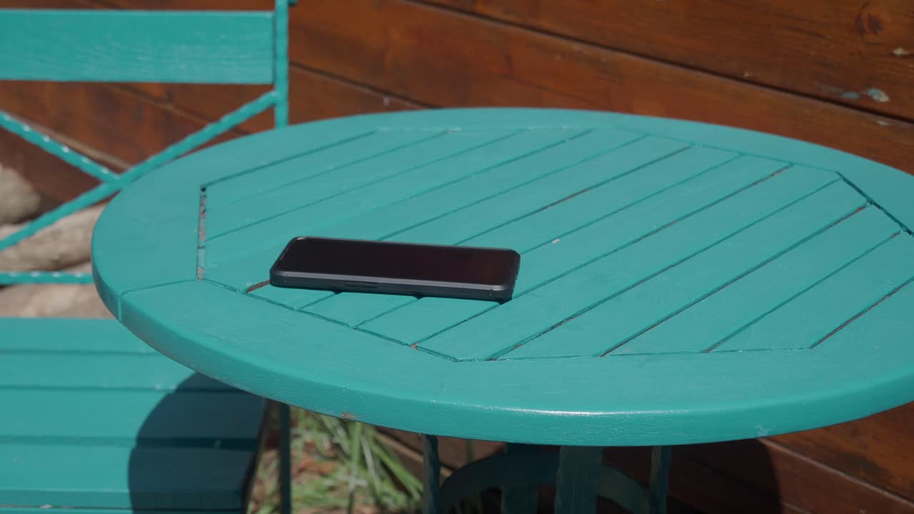 Cell phone on a turquoise table