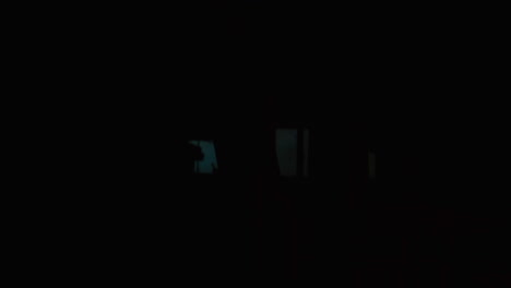 worker in dark industrial environment using safety gear