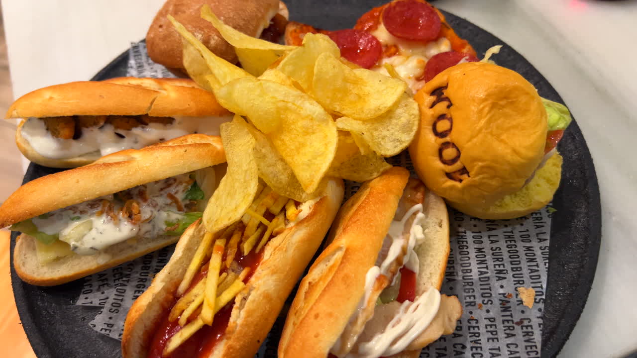 Full plate of 100 Montaditos mini sandwiches and mini burger with potato chips in Spain, small tapas, 4K shot