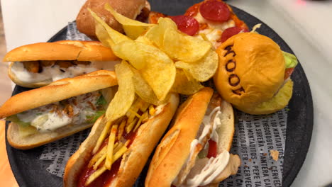 full plate of 100 montaditos mini sandwiches and mini burger with potato chips in spain, small tapas, 4k shot